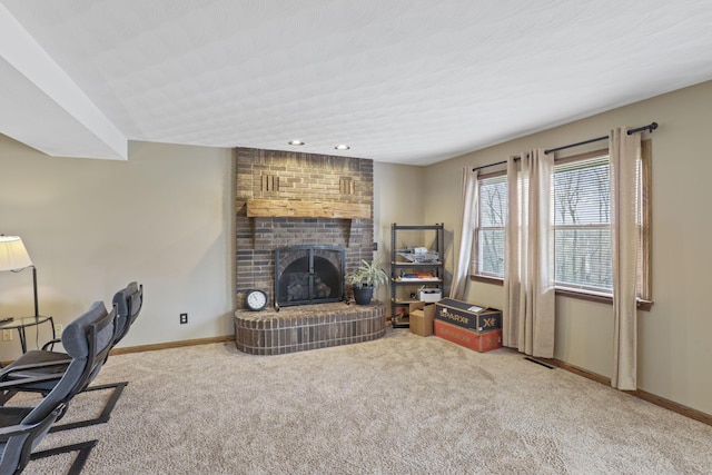 carpeted living room featuring baseboards, a brick fireplace, and recessed lighting