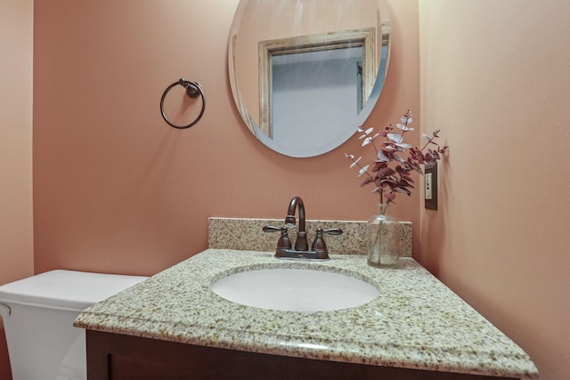 bathroom with toilet and vanity