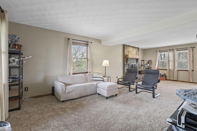 living area with baseboards, a wealth of natural light, and carpet