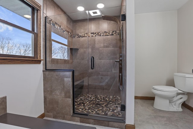 bathroom featuring tile patterned flooring, visible vents, toilet, baseboards, and a stall shower