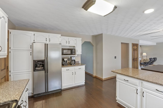 kitchen featuring built in microwave, baseboards, white cabinetry, stainless steel fridge with ice dispenser, and dark wood-type flooring