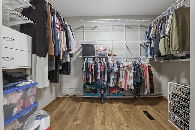 walk in closet with wood finished floors and visible vents
