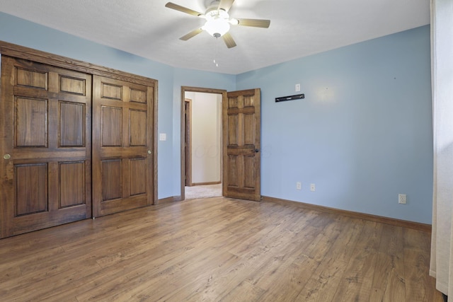unfurnished bedroom featuring baseboards, a ceiling fan, and light wood finished floors