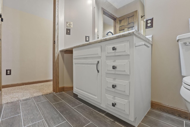 bathroom featuring wood tiled floor and toilet