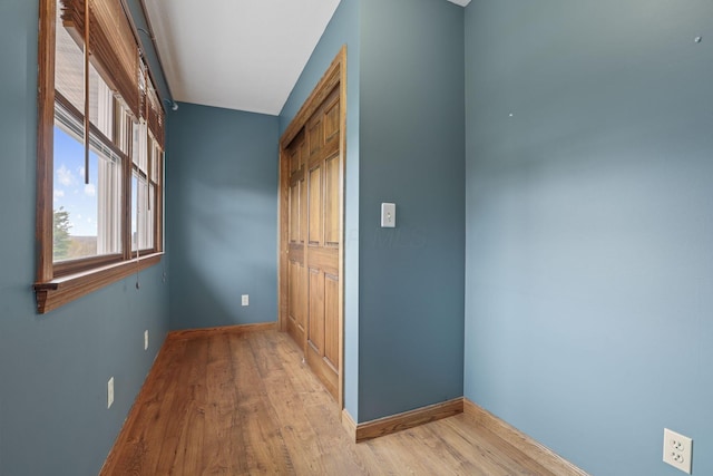 hallway with baseboards and wood finished floors
