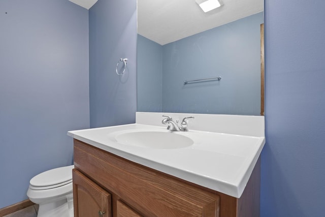 half bath featuring toilet and vanity