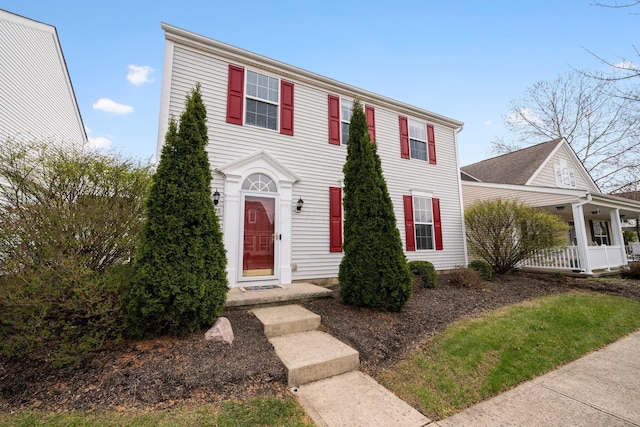 colonial-style house featuring covered porch