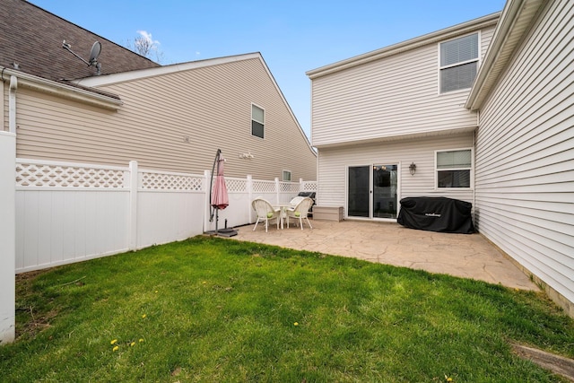 rear view of house featuring a patio area, fence, and a yard