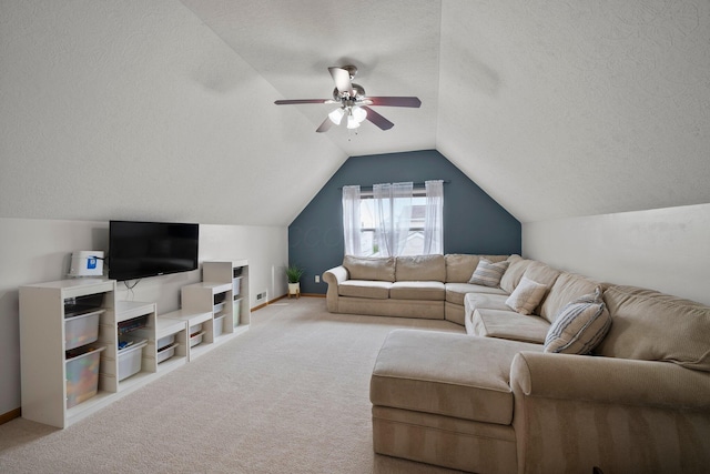 living area with carpet flooring, ceiling fan, a textured ceiling, baseboards, and lofted ceiling
