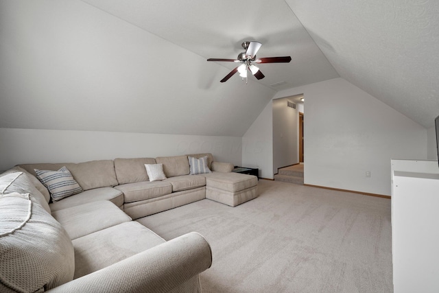 carpeted living area featuring baseboards, ceiling fan, visible vents, and lofted ceiling