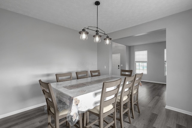 1065 Mastell Dr, Reynoldsburg, OH 43068 - dining space with dark wood finished floors, baseboards, and a textured ceiling