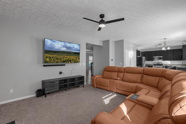 1065 Mastell Dr, Reynoldsburg, OH 43068 - living room with a ceiling fan, light carpet, a textured ceiling, a chandelier, and baseboards