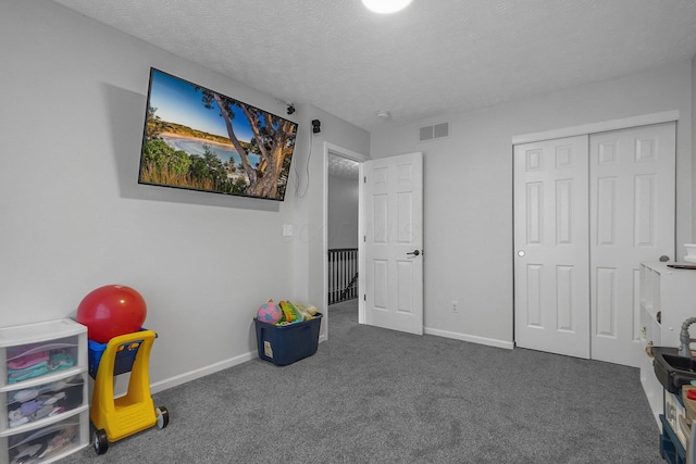 1065 Mastell Dr, Reynoldsburg, OH 43068 - recreation room with carpet flooring, a textured ceiling, and baseboards