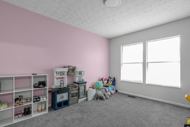 1065 Mastell Dr, Reynoldsburg, OH 43068 - recreation room with carpet flooring, a textured ceiling, and baseboards