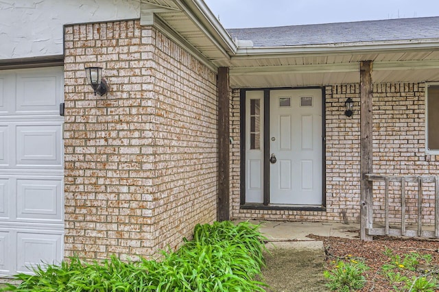 property entrance with brick siding