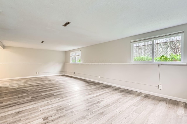 empty room featuring wood finished floors and baseboards