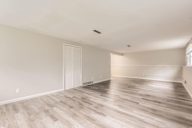 empty room featuring wood finished floors and baseboards