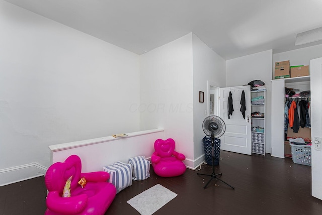 recreation room with baseboards and wood finished floors