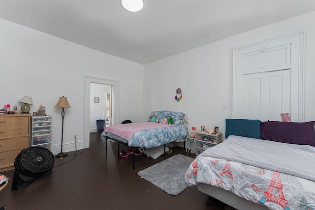 bedroom featuring wood finished floors and baseboards