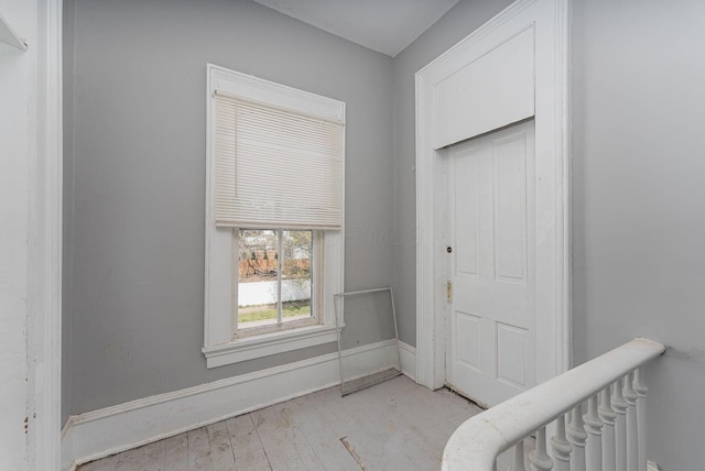 entrance foyer featuring baseboards and light wood finished floors