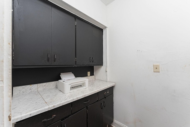 interior space with dark cabinetry and light countertops