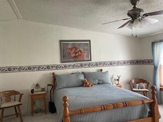 bedroom with carpet floors and a ceiling fan