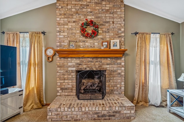 interior space featuring carpet flooring, a brick fireplace, and lofted ceiling