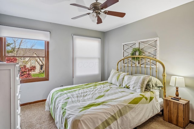 carpeted bedroom with baseboards and a ceiling fan