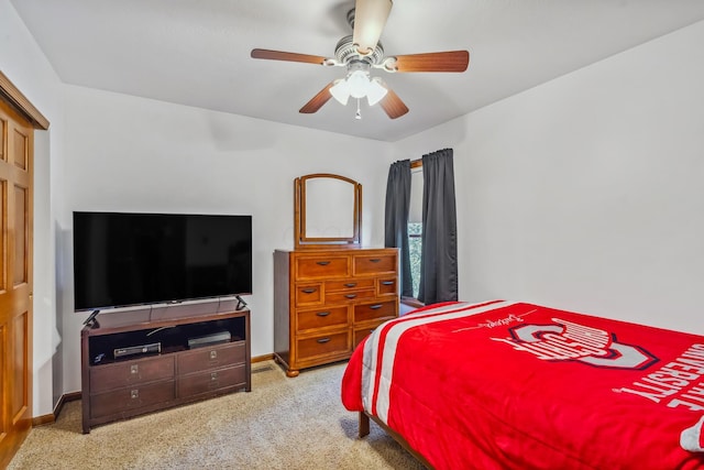 carpeted bedroom with baseboards and a ceiling fan