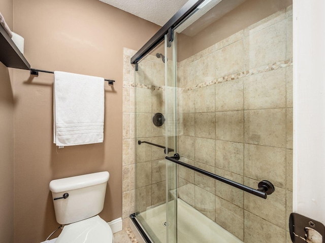 full bathroom with baseboards, toilet, and a stall shower