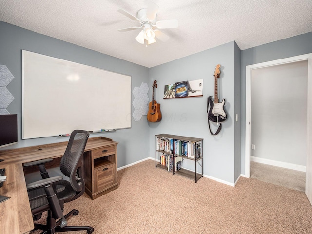 office space with baseboards, a ceiling fan, carpet flooring, and a textured ceiling