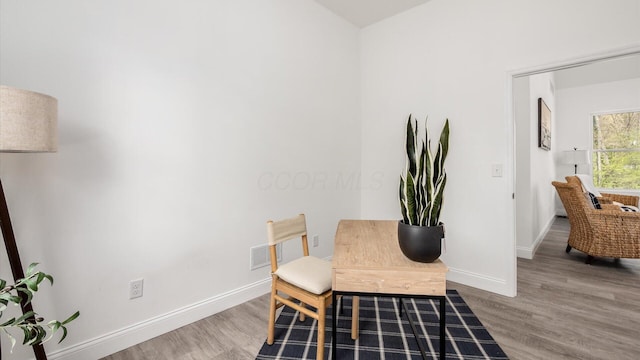 interior space featuring wood finished floors and baseboards