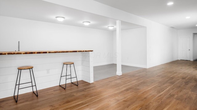 interior space featuring recessed lighting, wood finished floors, and baseboards