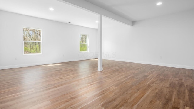 below grade area featuring baseboards, wood finished floors, and recessed lighting