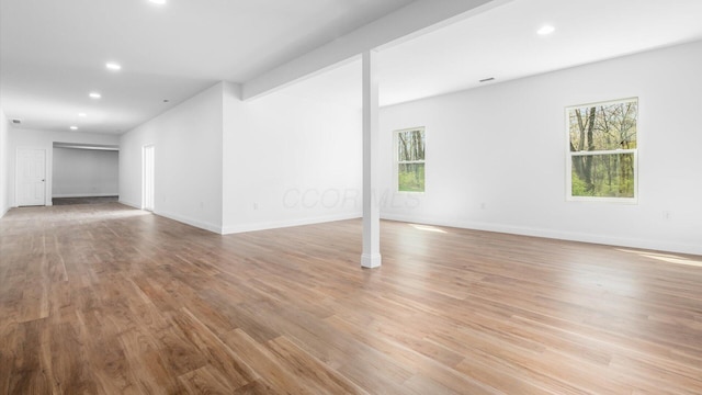 interior space featuring recessed lighting, light wood finished floors, and baseboards
