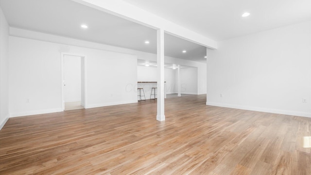 unfurnished living room with baseboards, light wood-style floors, and recessed lighting
