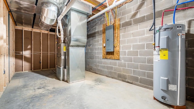 unfinished basement featuring electric panel, water heater, and concrete block wall