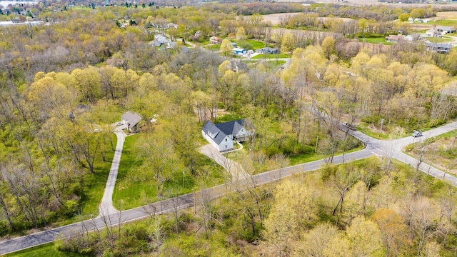 bird's eye view featuring a wooded view