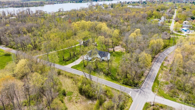 drone / aerial view featuring a forest view and a water view