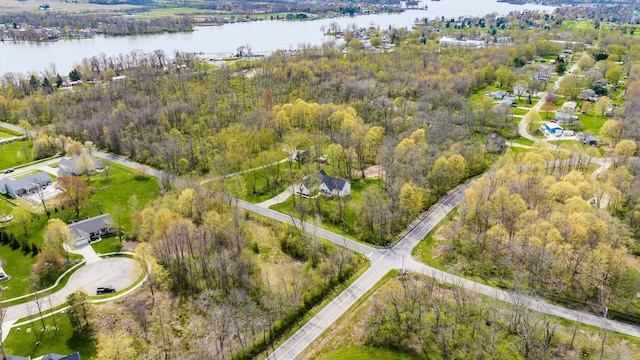 birds eye view of property featuring a view of trees and a water view