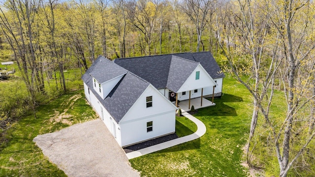 drone / aerial view featuring a forest view