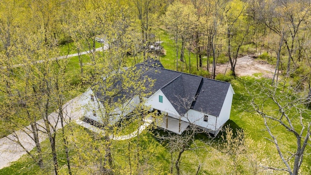 bird's eye view with a wooded view
