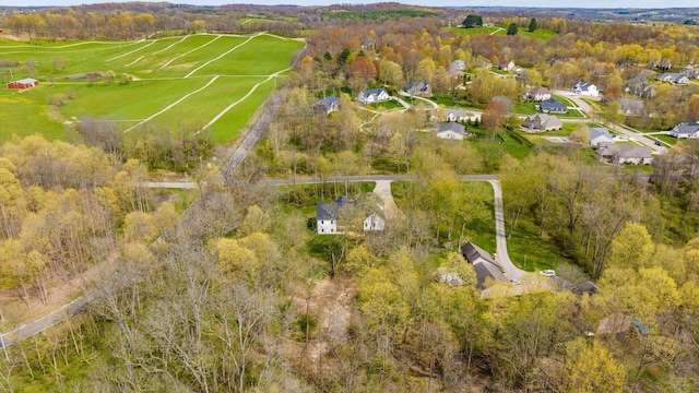 birds eye view of property featuring a wooded view
