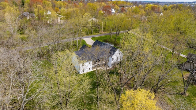 birds eye view of property with a wooded view