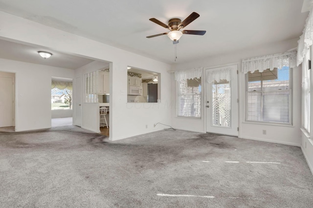 270 Mckinley Ave, New Lexington, OH 43764 - unfurnished living room featuring ceiling fan, baseboards, and carpet