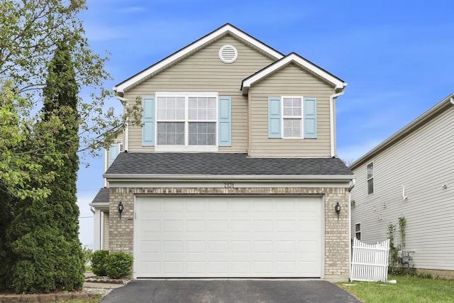 2131 Ripple Rd, Hilliard, OH 43026 - traditional-style house featuring a garage, fence, brick siding, and aphalt driveway
