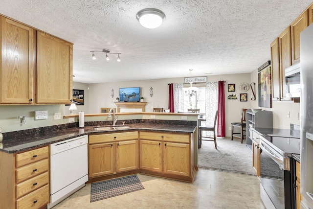 2131 Ripple Rd, Hilliard, OH 43026 - kitchen with white dishwasher, stainless steel range with electric stovetop, a sink, a peninsula, and dark stone counters