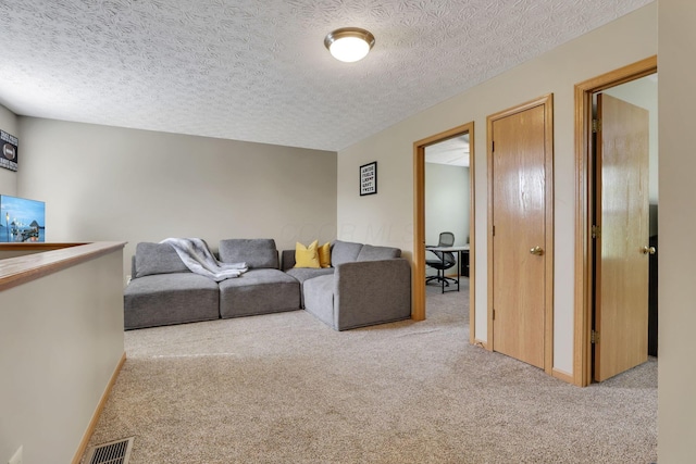 2131 Ripple Rd, Hilliard, OH 43026 - carpeted living area featuring visible vents and a textured ceiling