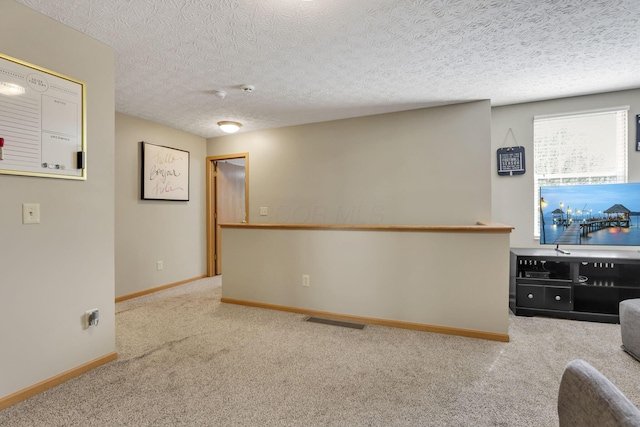 2131 Ripple Rd, Hilliard, OH 43026 - unfurnished living room with baseboards, carpet flooring, a textured ceiling, and visible vents