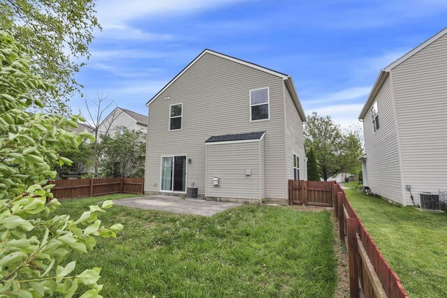 2131 Ripple Rd, Hilliard, OH 43026 - rear view of property with central air condition unit, a lawn, and a patio area